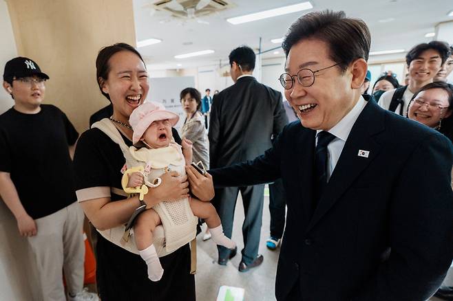 이재명 더불어민주당 대선 후보가 21대 대통령선거 사전투표 첫날인 29일 서울 서대문구 신촌동 주민센터에서 투표를 마치고 나오며 한 시민과 인사하고 있다. <연합뉴스-사진공동취재단>