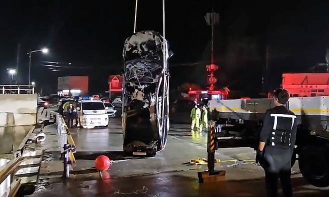 목포해경이 2일 밤 전남 진도군 진도항 인근에서 일가족이 탄 채로 바다에 빠진 차량을 인양하고 있다. 광주북부경찰은 가족 3명을 숨지게 한 혐의로 40대 남성을 광주에서 붙잡아 조사 중이다. 목포해경 제공