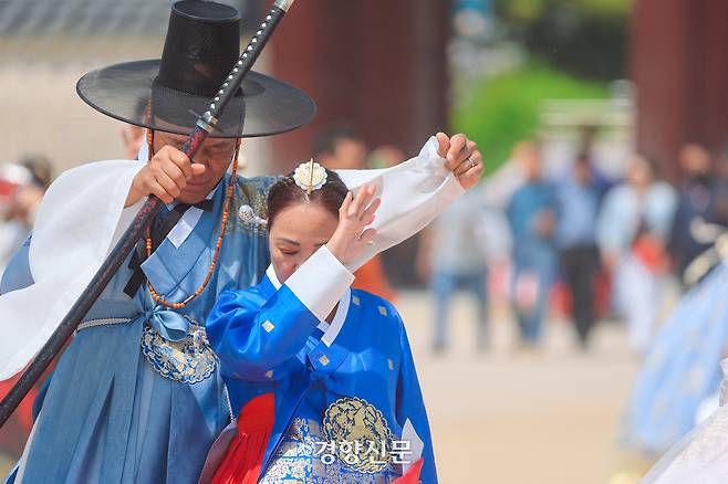6일 서울 경복궁을 찾은 한 관광객 커플이 갑자기 불어닥친 모래바람을 손으로 가리고 있다. 이준헌 기자