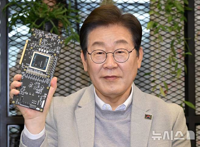 [서울=뉴시스] 국회사진기자단 = 이재명 더불어민주당 대선 예비후보가 14일 서울 강남구 퓨리오사AI에서 퓨리오사AI NPU칩을 들어 보이고 있다. 2025.04.14. photo@newsis.com