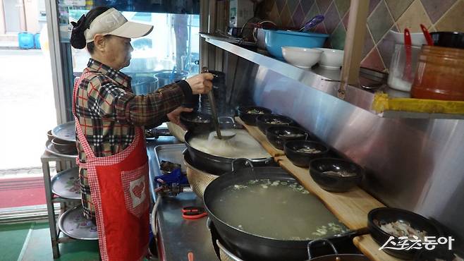 오랜 시간 푹 끓인 소머리국밥을 뚝배기에 담고 있는 장흥 정남진토요시장 ‘한라소머리국밥’ 사장님     장흥｜김재범 기자 oldfield@donga.com