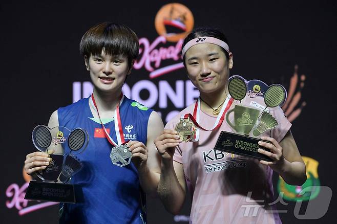 '셔틀콕 여제' 안세영(세계랭킹 1위)이 8일(현지시간) 인도네시아 자카르타에서 열린 세계배드민턴연맹(BWF) 월드투어 슈퍼 1000 인도네시아오픈 여자 단식 결승에서 중국의 왕즈이(세계랭킹 2위)를 상대로 2대1(13-21 21-19 21-15)로 우승한 후 왕즈이와 기념촬영을 하고 있다. 2025.6.8 ⓒ AFP=뉴스1 ⓒ News1 김성진 기자