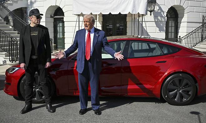 올해 3월 11일 미국 백악관에서 자신이 구입한 테슬라 차량을 홍보하는 도널드 트럼프 미국 대통령(오른쪽)과 일론 머스크 테슬라 최고경영자(CEO). 워싱턴=AP 뉴시스