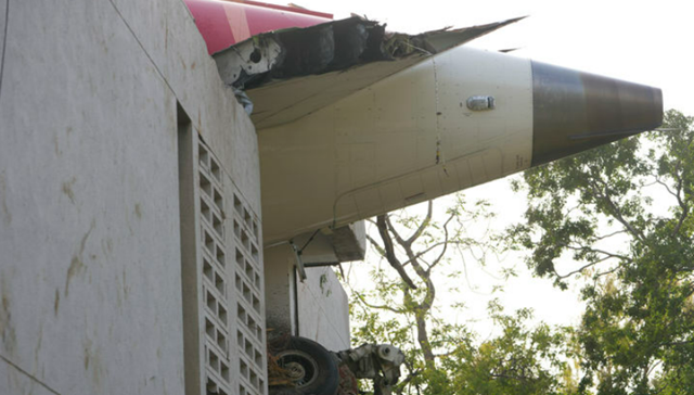 12일(현지시간) 인도 구자라트주 아마다바드에서 발생한 여객기 추락 사고 현장 건물 외벽에 기체 잔해가 튀어나와 있다. /AP·뉴시스