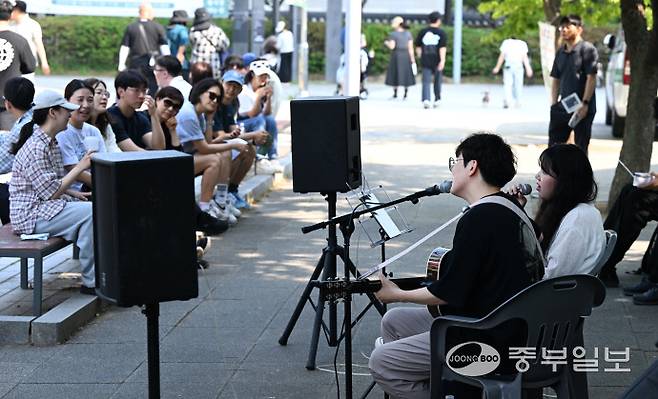 2025 송도굿마켓 부대행사로 열린 버스킹에서 시민들이 노래를 들으며 즐거운 시간을 보내고 있다.정선식기자