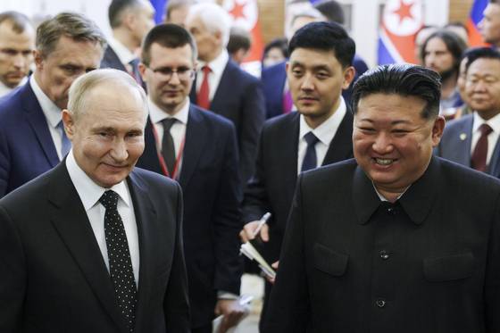 Russian President Vladimir Putin, left, and North Korea's leader Kim Jong Un smile together in Pyongyang, North Korea, on June 19, 2024. [AP/YONHAP]
