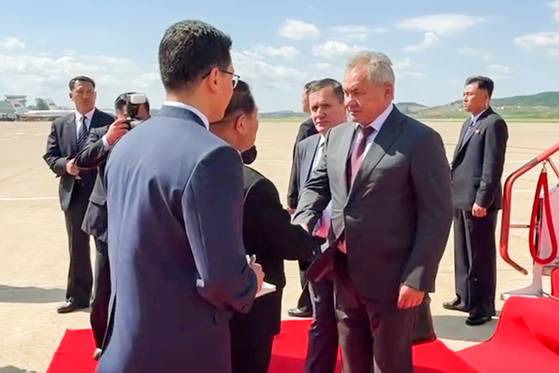 Russian Security Council Secretary Sergei Shoigu, right, is welcomed at a city airport on June 4. [TASS/YONHAP]