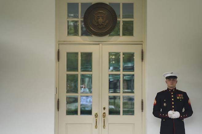 도널드 트럼프 미국 대통령이 17일(현지시간) 워싱턴 백악관 상황실에서 약 80분간 긴급 안보회의를 열어 이스라엘의 이란 핵 시설 공습에 대한 미국의 지원 방안을 논의한 것으로 보인다. 회의가 열리고 있는 상황실 앞을 미 해병 병사가 지키고 있다. AP 연합