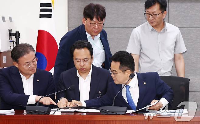 더불어민주당 을지로위원회 민병덕 위원장(앞줄 오른쪽)과 김범석 우아한형제들 대표(가운데)가 19일 오전 서울 여의도 국회에서 배달앱(배달의민족) 사회적대화기구 중간합의문 발표 브리핑에서 중간합의문에 서명하고 있다. 2025.6.19/뉴스1 ⓒ News1 김민지 기자