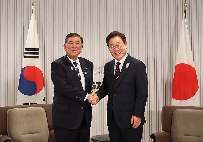 이재명 대통령과 이시바 시게루 일본 총리가 17일(현지시간) 캐나다 앨버타주 캐내내스키스 주요 7개국(G7) 정상회의장에서 열린 한일 정상회담에서 악수하고 있다. [연합]