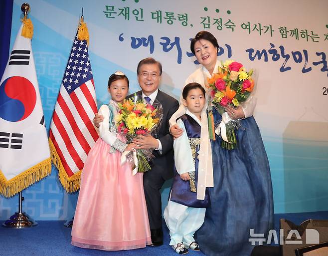 [워싱턴=뉴시스] 전신 기자 = 지난 2017년 7월 1일(현지 시간) 문재인 전 대통령과 부인 김정숙 여사가 미국 워싱턴 캐피탈 힐튼 호텔에서 열린 동포 간담회에 참석하며 화동으로부터 환영의 꽃다발을 받고 있다. 2025.06.19. photo@newsis.com