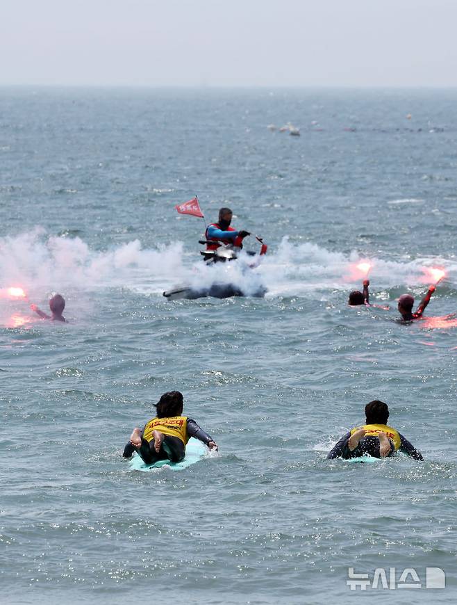 [부산=뉴시스] 하경민 기자 = 부산해경과 서프구조대 등이 19일 부산 해운대구 송정해수욕장에서 이안류 등으로 피서객이 먼 바다로 떠내려가는 상황을 가정한 합동 구조훈련을 하고 있다.부산지역 7개 해수욕장 중 해운대와 송정 해수욕장은 오는 21일 문을 열고, 광안리·송도·다대포·일광·임랑 등 나머지 5개 해수욕장은 오는 7월1일 일제히 개장한다. 2025.06.19. yulnetphoto@newsis.com