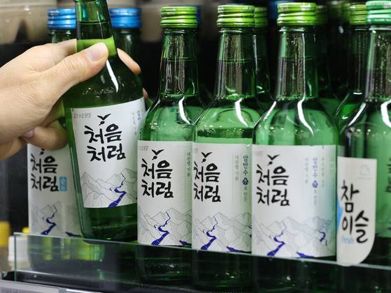 Bottles of soju are displayed at a supermarket in Seoul. [YONHAP]