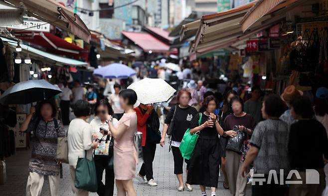 [서울=뉴시스] 김선웅 기자 = 정부가 30조5000억원 규모의 2차 추가경정예산(추경)안을 편성했다. 정부는 19일 이재명 대통령 주재로 국무회의를 열고 2차 추경안을 심의·의결했다. 이번 추경으로 인해 늘어나는 재정 지출은 20조2000억원으로 경기 진작과 민생 회복을 위해 전 국민 민생회복 소비 쿠폰 지급, 사회간접자본 투자, 취약 소상공인 채무 조정 등의 사업들을 추진할 계획이다. 나머지 10조3000억원은 세입 예산 규모를 조정하는 '세입 경정'이다. 19일 서울 시내 상점가에서 시민들이 오가고 있다. 2025.06.19. mangusta@newsis.com