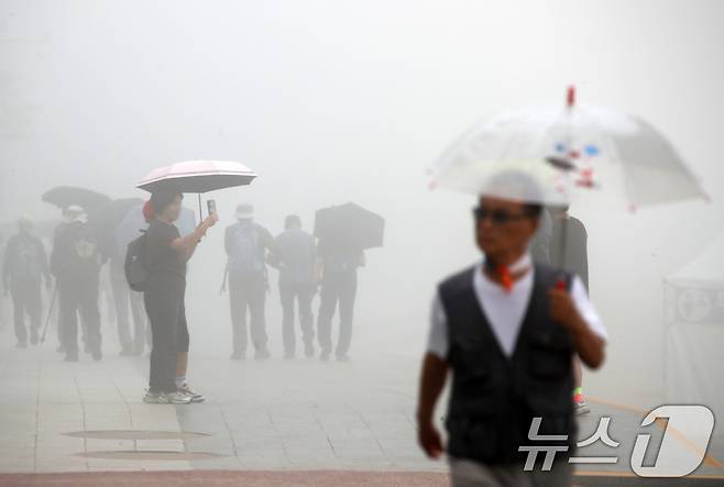 부산 해운대해수욕장에서 우산을 쓴 시민들이 발걸음을 옮기고 있다. 2025.6.20/뉴스1 ⓒ News1 윤일지 기자