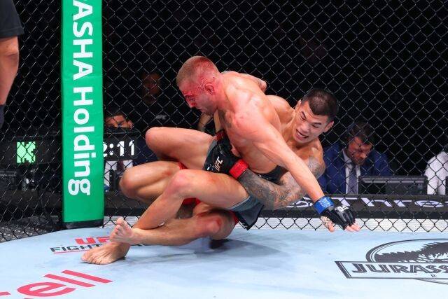 고석현(오른쪽)이 엘리엇과 경기에서 테이크 다운을 성공하고 있다. /UFC 제공