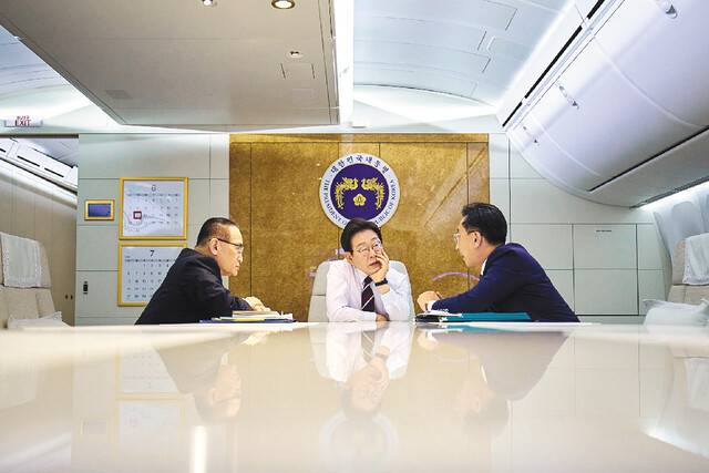 이재명 대통령이 지난 16일 주요 7개국(G7) 정상회의 참석을 위해 캐나다 캘거리를 향하는 도중 공군 1호기에서 위성락(왼쪽) 국가안보실장, 김태진 외교부 의전장과 대화하고 있다. 김지훈 기자