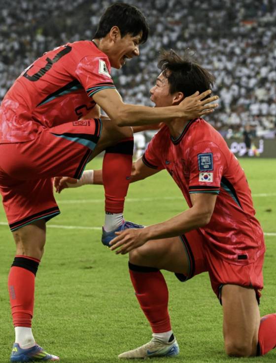이라크전에서 전진우(왼쪽)와 ‘축구화 닦기’ 세리머니를 재연한 오현규. [AFP=연합뉴스]