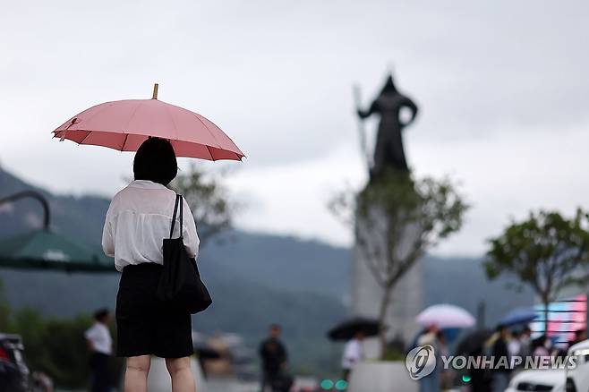 비 오는 출근길 (서울=연합뉴스) 윤동진 기자 = 비 오는 25일 오전 서울 세종로사거리에서 시민들이 우산을 쓴 채 보행 신호를 기다리고 있다. 2025.6.25 mon@yna.co.kr