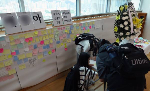 전날 아파트 화재로 숨진 자매가 다닌 부산 한 초등학교에 25일 추모 공간이 마련돼 있다. 연합뉴스