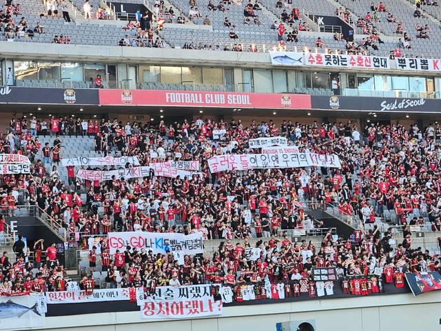 FC 서울 팬들이 29일 FC서울과 포항 스틸러스전이 열린 서울월드컵경기장에서 기성용 이적을 결정한 구단과 김기동 감독을 비난하는 내용의 플래카드를 내건 채 항의 표시를 하고 있다. 연합뉴스