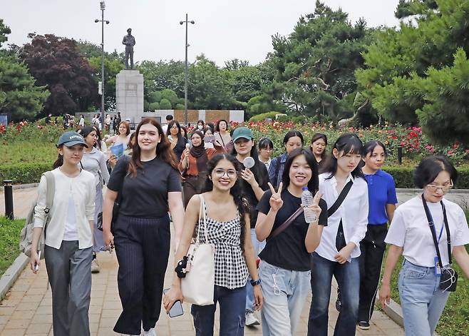 Students explore Jayu Park on June 27, with the statue of General MacArthur in the back. [PARK SANG-MOON]