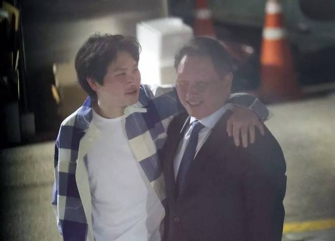 최태원 SK그룹 회장이 2024년 6월 5일 서울 강남구 한 식당 앞에서 장남인 최인근 씨와 어깨동무를 한 채 대화하는 모습 포착됐다. 사진=온라인 커뮤니티 캡처