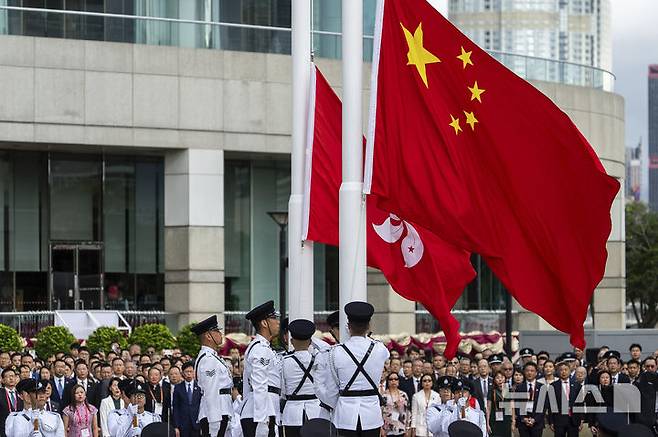 [홍콩=AP/뉴시스] ﻿﻿유럽연합(EU)과 짐 리시 미국 상원 외교위원장이 홍콩국가보안법 시행 5주년을 맞아 홍콩의 자유가 위축됐다고 비판한 가운데, 중국 당국이 이를 강하게 반박하고 나섰다. 사진은 1일 홍콩에서 홍콩 반환 28주년 기념식이 열려 경찰 의장대가 중국 국기와 홍콩 특별행정구 깃발을 게양하는 모습. 2025.07.02