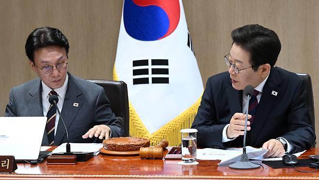 President Lee Jae Myung, right, speaks with Prime Minister Kim Min-seok at a Cabinet meeting held at the Yongsan presidential office central Seoul on July 5. [PRESIDENTIAL OFFICE]