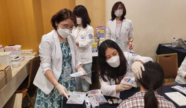경기도 용인 새에덴교회 응급의료대응팀 소속 의료진이 최근 환자의 열을 재고 있는 모습. 새에덴교회 제공