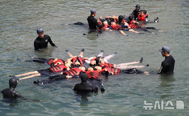 [서귀포=뉴시스] 우장호 기자 = 8일 오전 제주 서귀포시 법환 해녀체험장에서 제주도교육청과 해녀·해군기동함대사령부가 협동해 강정초등학교 학생들에게 '제주형 생존수영' 교육을 하고 있다. 이번 생존수영 교육은 법환 어촌계 해녀, 해군 해난구조대(SSU)가 함께하는 전국 최초의 프로그램으로 서귀포시 관내 초등학교 5~6학년 학생 100여명(3개교)을 대상으로 8월15일까지 운영된다. 2025.07.08. woo1223@newsis.com