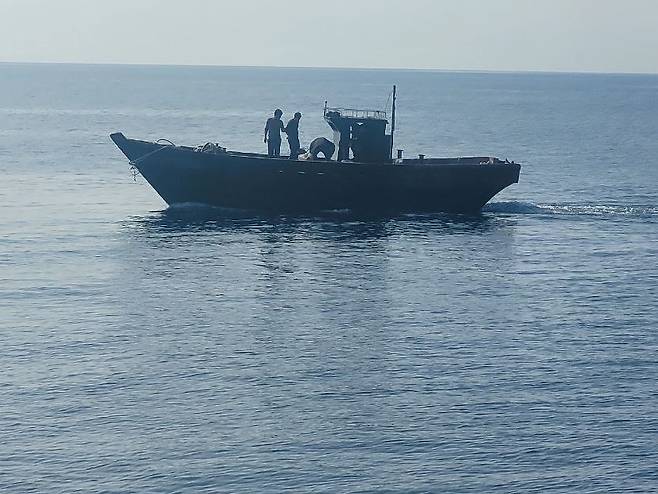 A wooden boat carrying North Koreans moves northward in the East Sea on Wednesday. (Ministry of Unification)