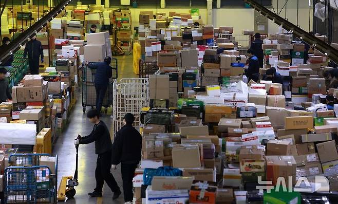 [서울=뉴시스] 고범준 기자 = 21일 오전 서울 광진구 동서울우편물류센터에서 직원들이 설 명절을 앞두고 택배를 분류하고 있다.  (기사 내용과 관련 없음). 2025.01.21. bjko@newsis.com