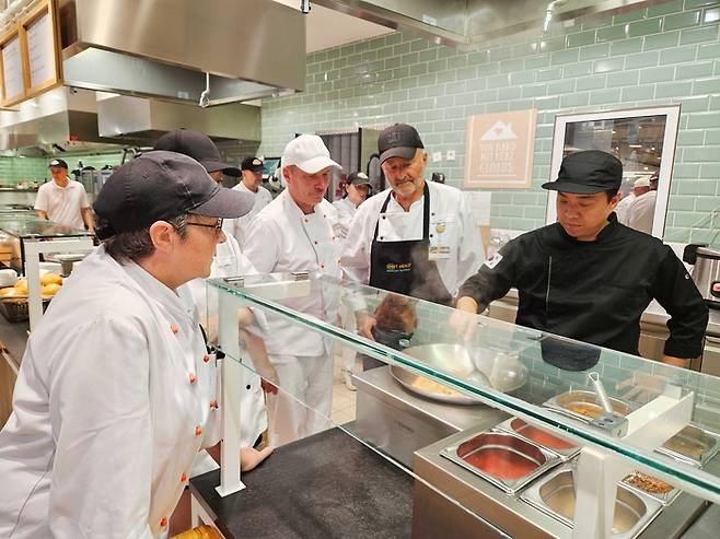 독일 글로버스 현지 조리사들에게 더본코리아 직원이 컨설팅 하는 모습. [사진 출처 = 더본코리아]