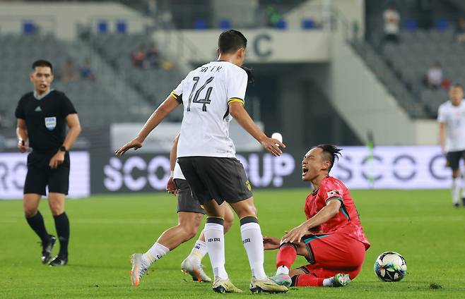 한국 문선민이 7일 동아시안컵 중국전에서 파울을 당한 뒤 고통스러워하고 있다. 연합뉴스