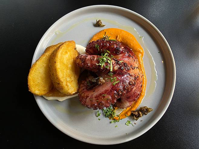 A signature grilled octopus dish at WIP Seongsu paired with Romanesco sauce and potatoes [JIN EUN-SOO]