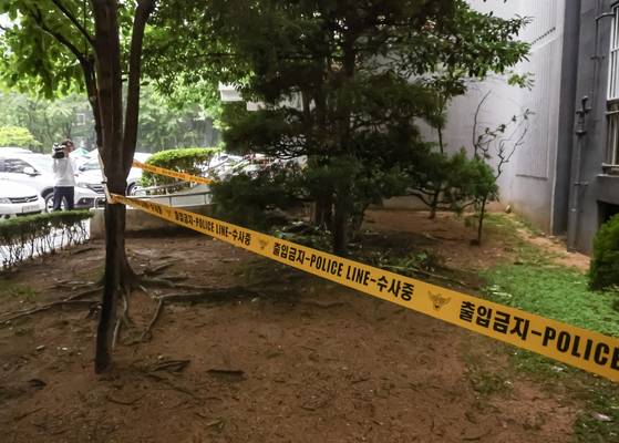 지난달 21일 오전 고등학생 3명이 함께 숨진 채 발견된 부산 해운대구 한 아파트 화단. 22일 경찰이 폴리스라인으로 출입을 통제하고 있다. 송봉근 기자