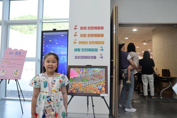 12일 '2025 열두빛깔 어울림 한마당 우리고장 알리기 그리기 대회' 시상식에서 대상을 수상한 강로이(금천초) 학생이 자신의 작품 '상당산성'과 함께 기념사진을 찍고 있다. 사진=이용민 기자