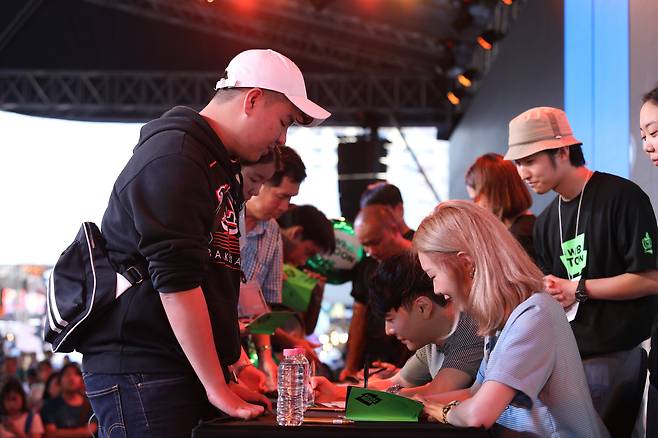 Korean webtoonists including Min Songa attend a signing event in Thailand in 2019. [NAVER WEBTOON]