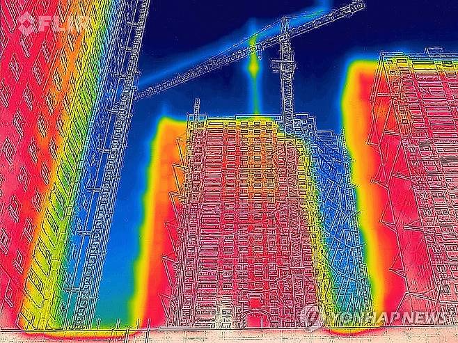 붉게 타오르는 아파트 신축 공사 현장 낮 최고기온이 36.7도까지 올라 7월 상순 기온값 신기록이 세워진 7월 9일 오전 광주 서구 한 아파트 신축 공사 현장을 열화상 카메라로 촬영한 모습. 온도가 낮은 곳은 푸르게, 높은 곳은 붉게 표시돼 있다. [연합뉴스 자료사진]