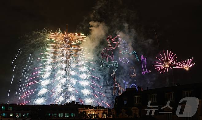 14일(현지시간) 프랑스 혁명 기념일(바스티유 데이)을 기념하기 위해 에펠탑에 펼쳐진 불꽃놀이 쇼에서 불꽃과 함께 1천100대의 드론이 여러 동물의 형상을 연출하고 있다. 2024.7.15/뉴스1 ⓒ News1 이준성 기자