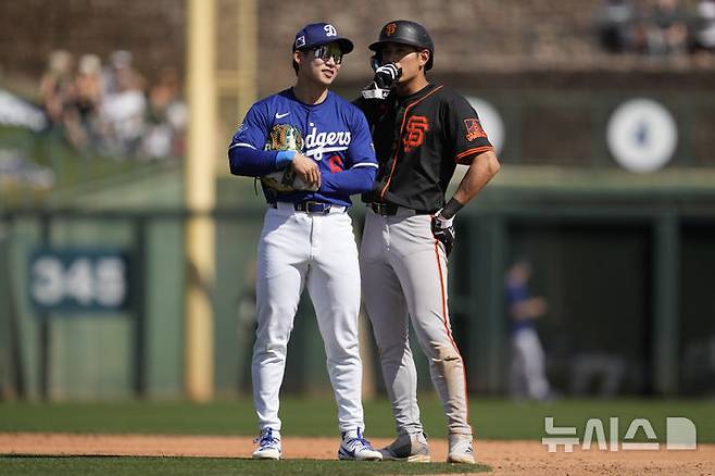 [피닉스=AP/뉴시스] 로스앤젤레스 다저스 유격수 김혜성(왼쪽)과 샌프란시스코 자이언츠 이정후가 1일(현지 시간) 미 애리조나주 피닉스 캐멀백 랜치에서 열린 2025 MLB 시범 경기 3회 투수 교체 시간 중 2루 근처에서 얘기를 나누고 있다. 김혜성은 2타수 1안타(1홈런) 3득점 1볼넷, 이정후는 3타수 2안타 1타점을 기록했고 다저스가 6-5로 승리했다. 2025.03.02.