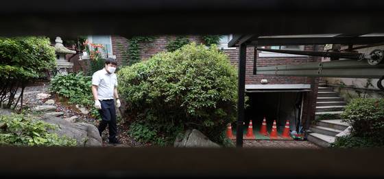 김건희 여사 관련 의혹들을 수사하는 민중기 특별검사팀이 15일 서울 역삼동 건진법사 전성배씨의 법당에 대한 압수수색에 나선 가운데 특검 관계자들이 비밀 공간이 연결된 지하 차고를 향해 가고 있다. 연합뉴스