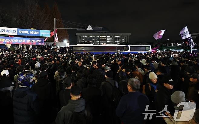 윤석열 대통령이 비상계엄령을 선포한 가운데 4일 새벽 서울 여의도 국회 앞에 모인 시민들이 "계엄 해제＂ 구호를 외치고 있다. 2024.12.4/뉴스1 ⓒ News1 구윤성 기자