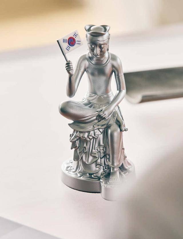 '데니 태극기'를 들고 있는 반가사유상 미니어처 광복 에디션. '데니 태극기'는 현재까지 발견된 태극기 중 가장 오래된 태극기로, 조선 말기 고종의 외교 고문이었던 미국인 오웬 니커슨 데니가 보관하고 있다가 그 후손이 국립중앙박물관에 기증했다. 1880년대 중반에 제작된 것으로 추정된다. 국립박물관문화재단 제공