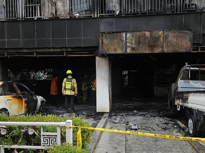 18일 오전 소방이 사고 현장에 들어가 화재 원인을 밝히기 위한 감식에 들어갔다. 양옆에는 화재로 인해 그을린 차량과 트럭이 세워져 있다. /사진=박상혁 기자.