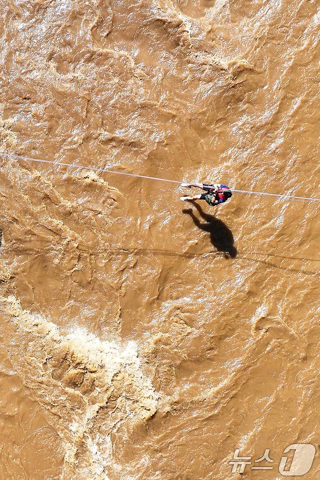 20일 경기 가평군 마일리의 한 캠핑장에 고립된 시민들이 소방 로프를 타고 탈출하고 있다. 2025.7.20/뉴스1 ⓒ News1 신웅수 기자