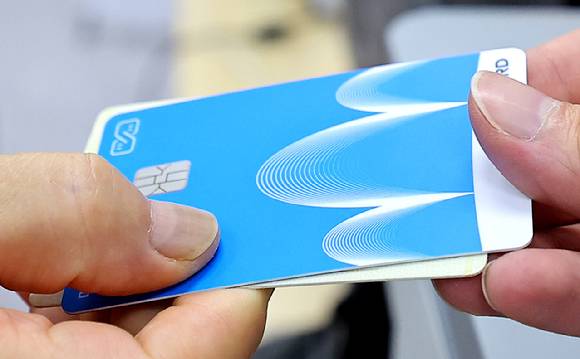 민생회복 소비쿠폰 1차 신청 첫날일 21일 인천 미추홀구 숭의1·3동 행정복지센터에서 한 시민이 신청한 선불카드를 받고 있다. [사진=연합뉴스]