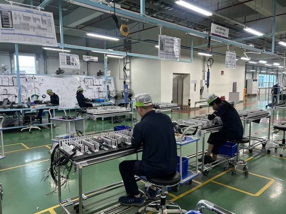 Workers produce power systems at LS Electric's manufacturing plant in Bac Ninh, the outskirts of Hanoi, Vietnam. [SARAH CHEA]