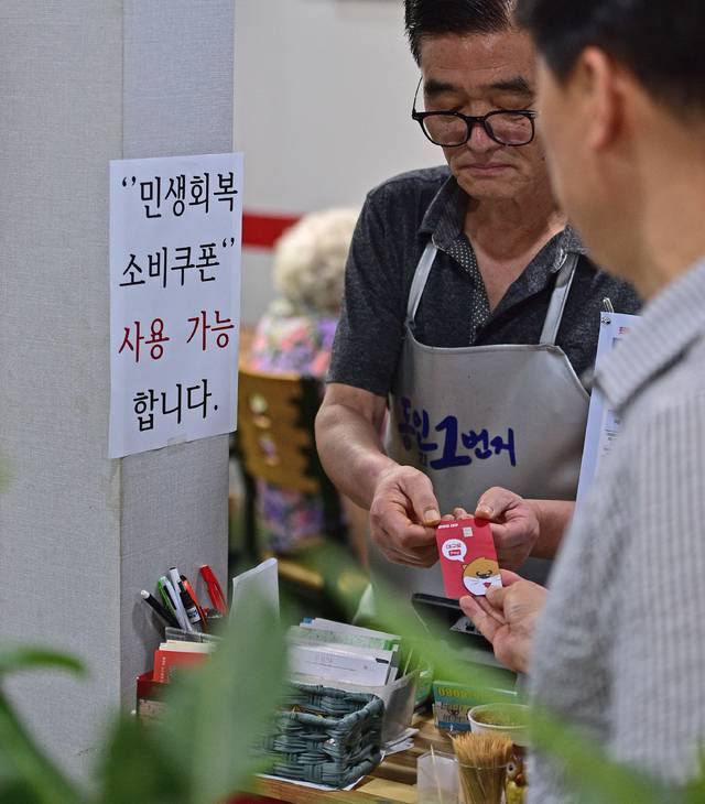 2일 오후 대구 중구의 한 음식점에서 식사를 마친 시민이 민생회복 소비쿠폰이 입금된 대구사랑상품권(대구로페이) 카드로 식대를 결제하고 있다. 김진홍 기자